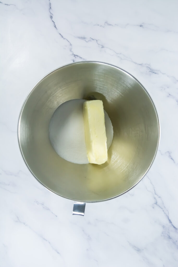 A picture of butter and sugar in a tin bowl.