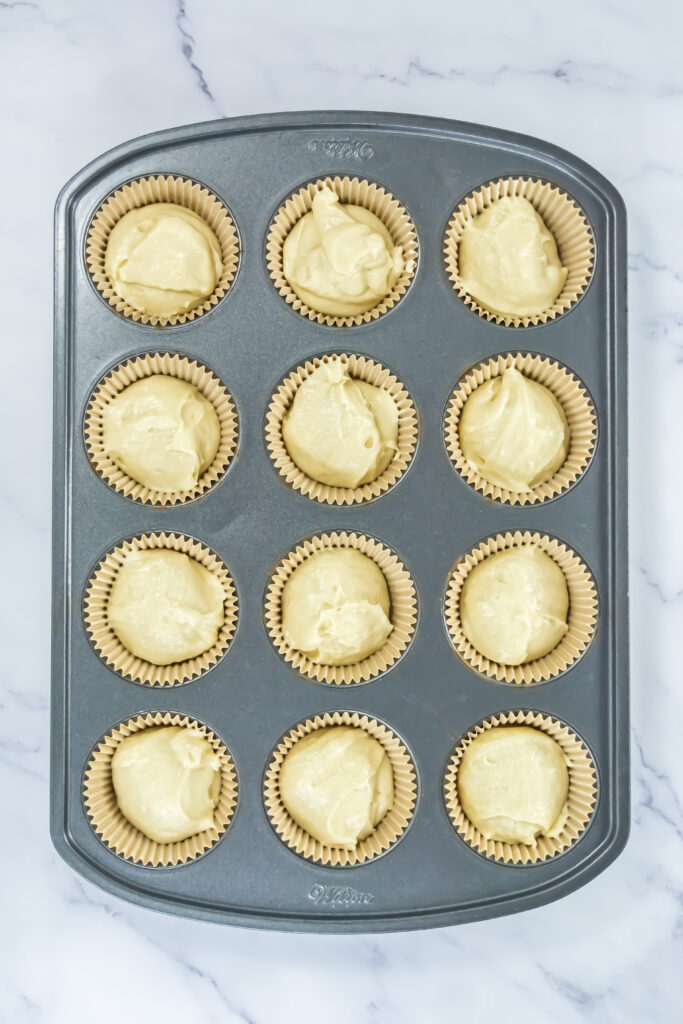 A picture of cupcake tins filled with cupcake dough.