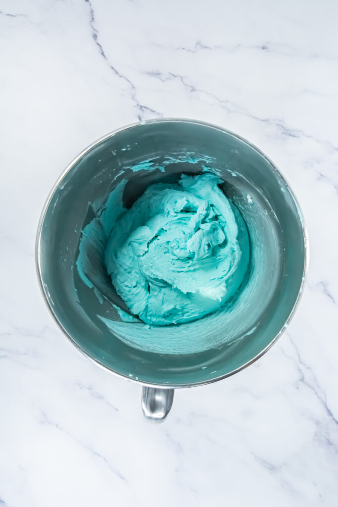 A picture of blue buttercream frosting in a bowl.