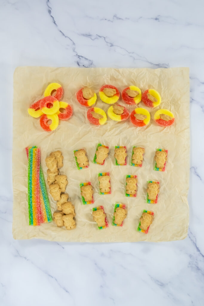 A picture of Teddy Graham cookies laid on top of sliced Air Head candies to resemble beach towels.