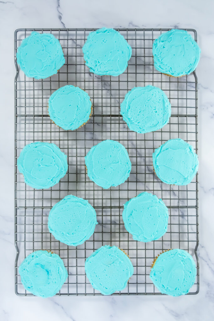 A picture of cupcakes decorated with blue frosting.