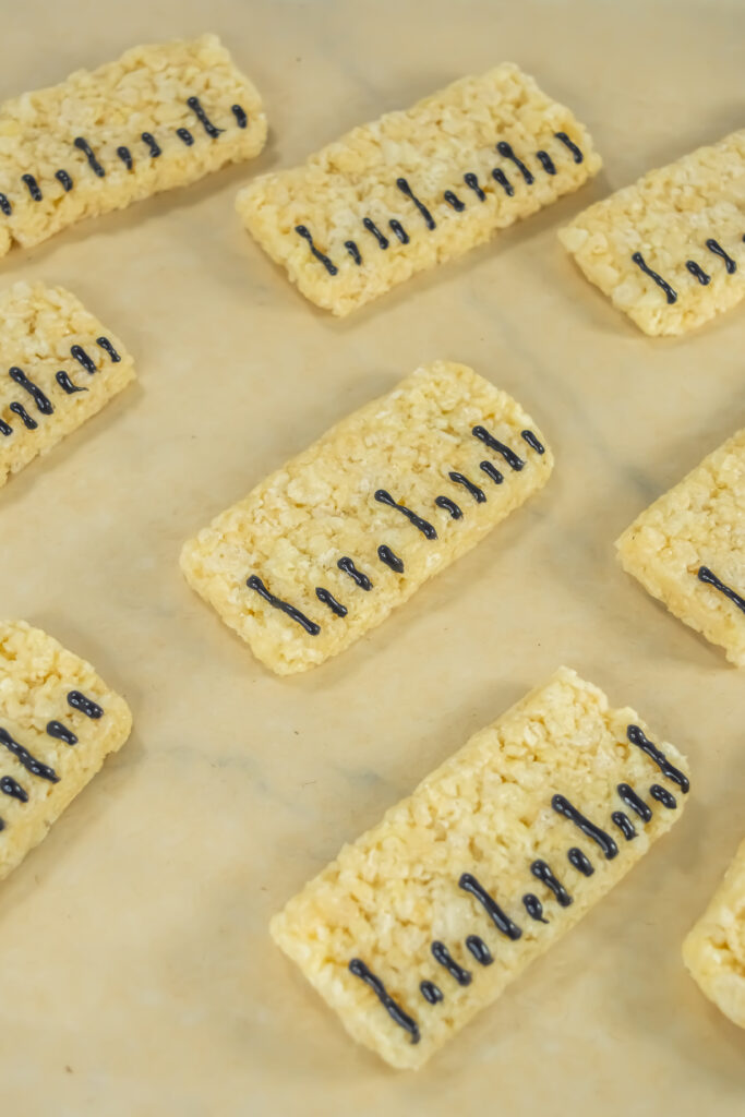 A close up picture of rice krispy treats decorated to look like rulers.