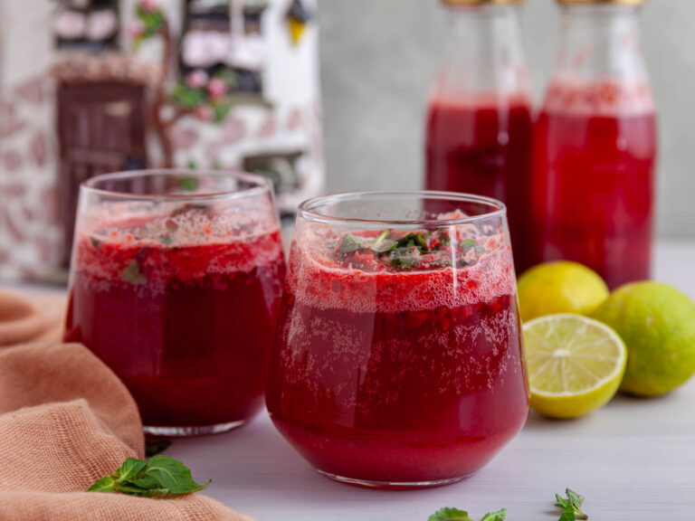 A ppicture of two glasses of dark cherry mint fizz drink.