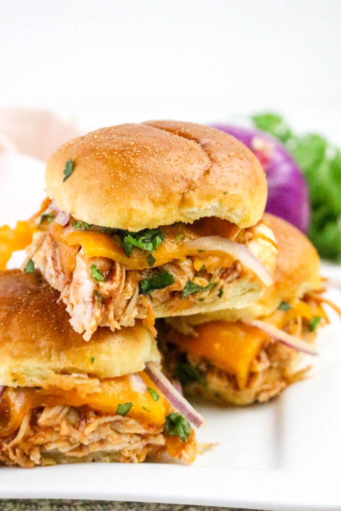 A close up picture of three chicken sliders.