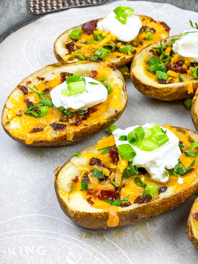 A close up picture of loaded baked potato skins.