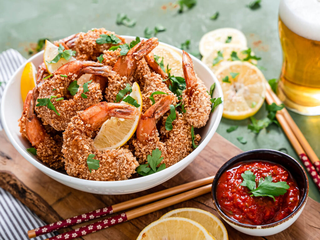 A picture of a basket of of fried lemon panko shrimp.