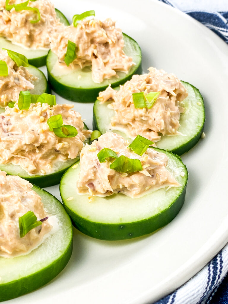 A close up picture of cucumber rounds topped with spicy tuna.