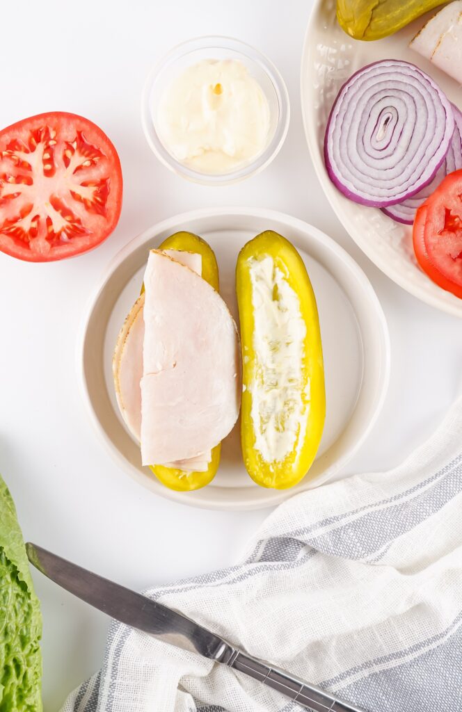 Fold the turkey and tuck it in with some hanging over the edge.