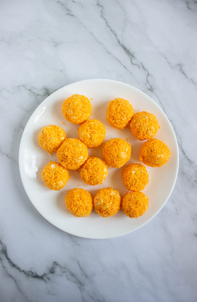 A picture of a set of cheese balls on a plate.