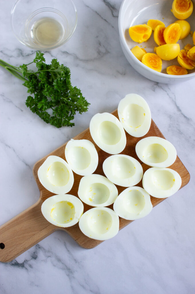 A picture of several hard boiled egg halves with the yolks removed.