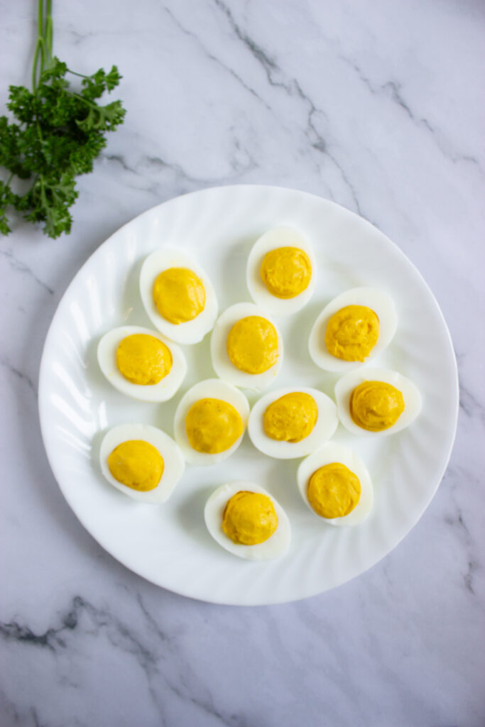A picture of a set of deviled eggs filling a plate.