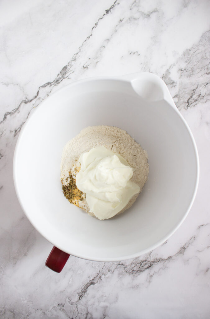 A picture of flour, spices, and greek yogurt in a bowl.