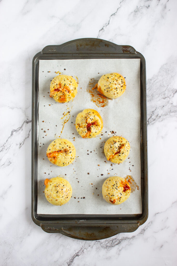 A picture of fully baked and seasoned pizza bagel bites.
