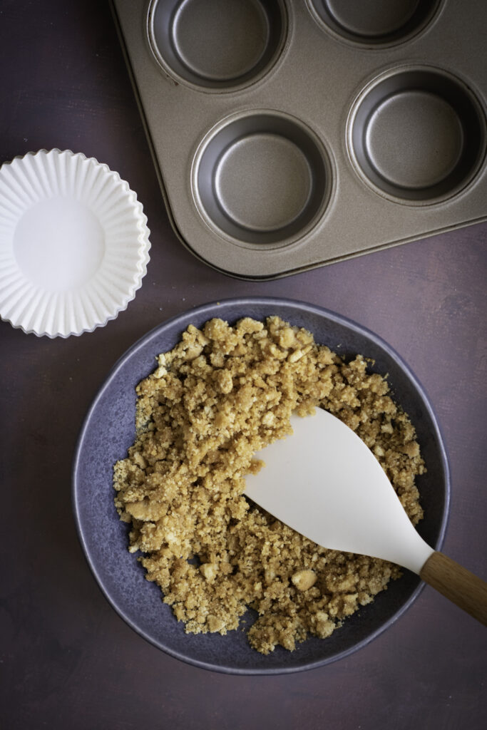 A picture of graham cracker crumbs, granulated sugar, and melted butter mixed together in a bowl.