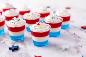 red white and blue jello shots on a table