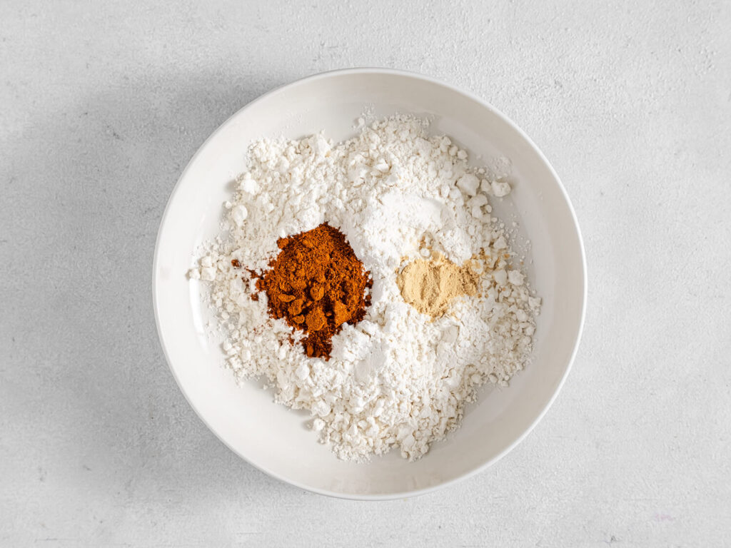 A picture of various spices in a bowl, unmixed.