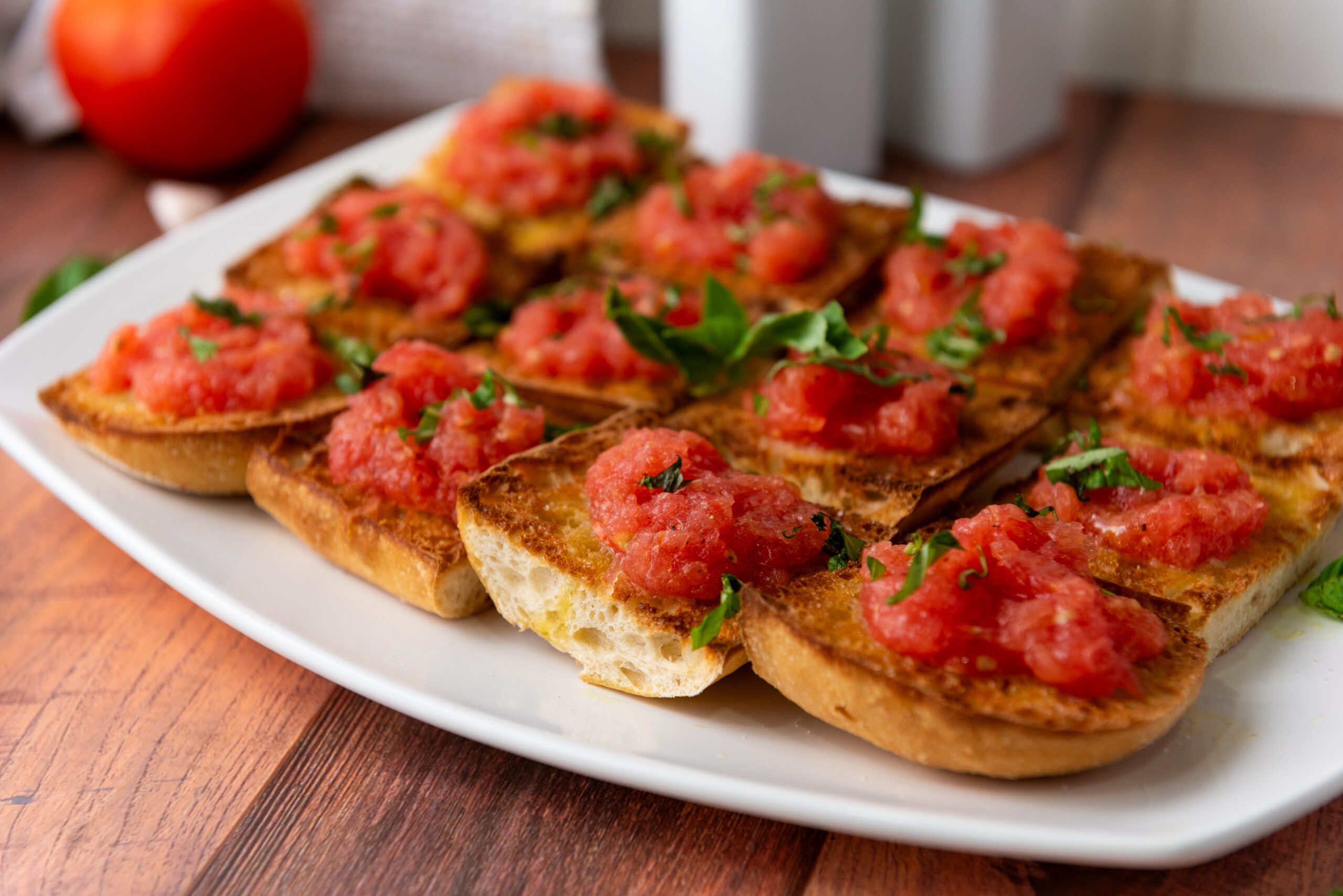 A picture of a tray of spanish pan con tomate.