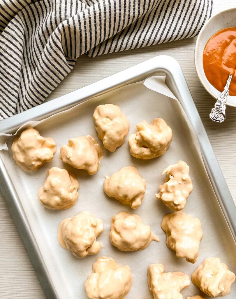 A picture of battered uncooked cauliflower wings.