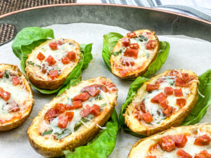 An isometric picture of potato skins stuffed with pepperoni and cheese.