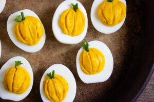 A picture of six pumpkin deviled eggs.