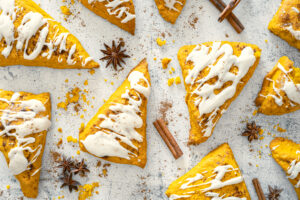 A picture of a set of frosted pumpkin scones.