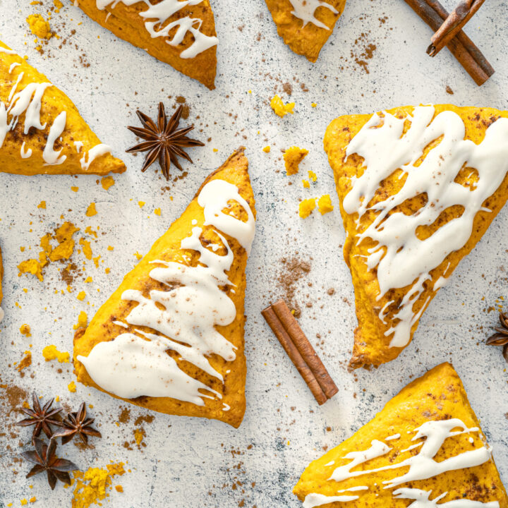 A picture of a set of frosted pumpkin scones.