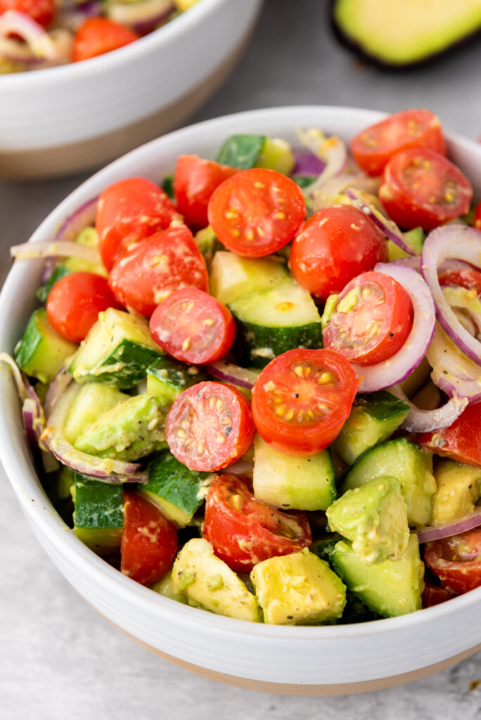 A zoomed in picture of a bowl of avocado salad.