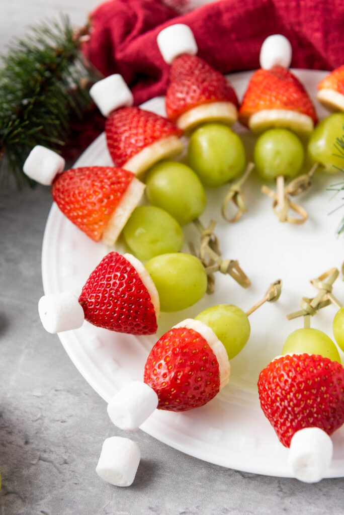 A close up picture of Christmas fruit skewers arranged in a circle.