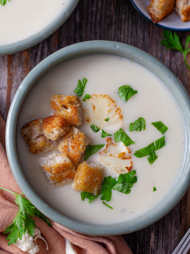 A top down photo of a bowl of cauliflower soup.