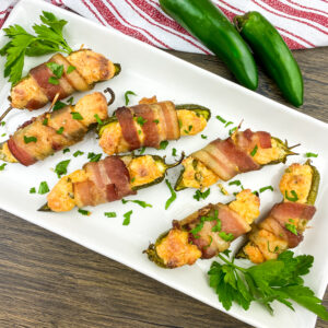 A picture of seven bacon wrapped jalapeno poppers.