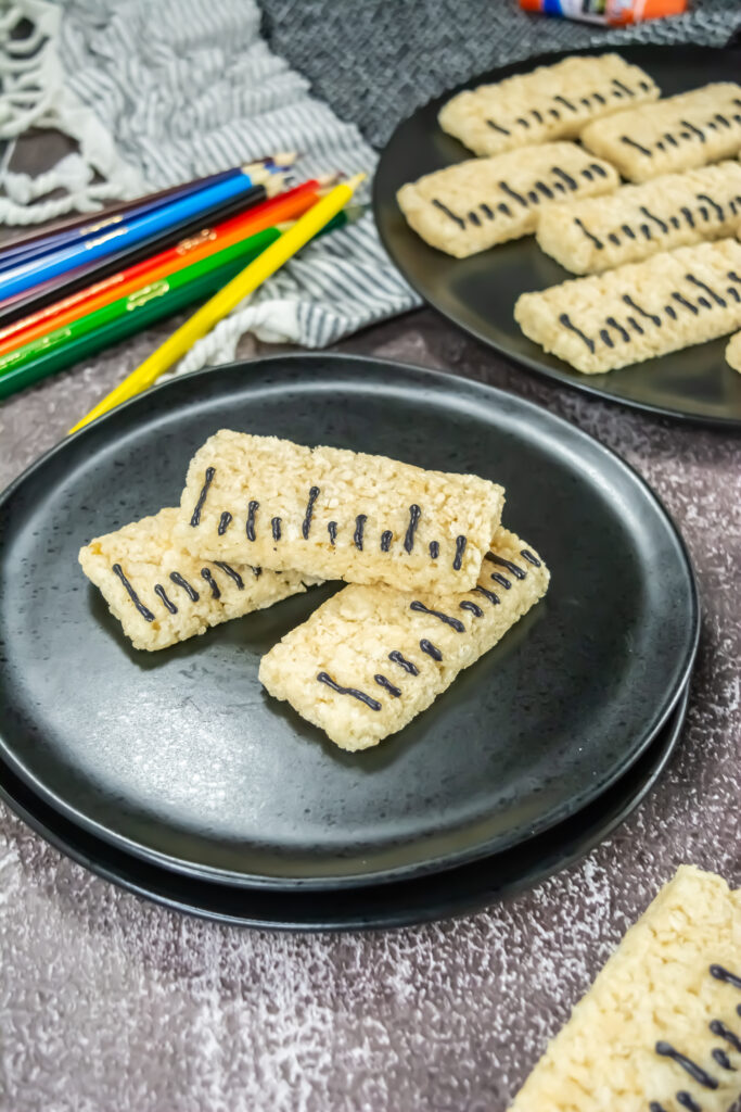 A picture of three ruler rice krispy treats with one stacked on top of the other two.