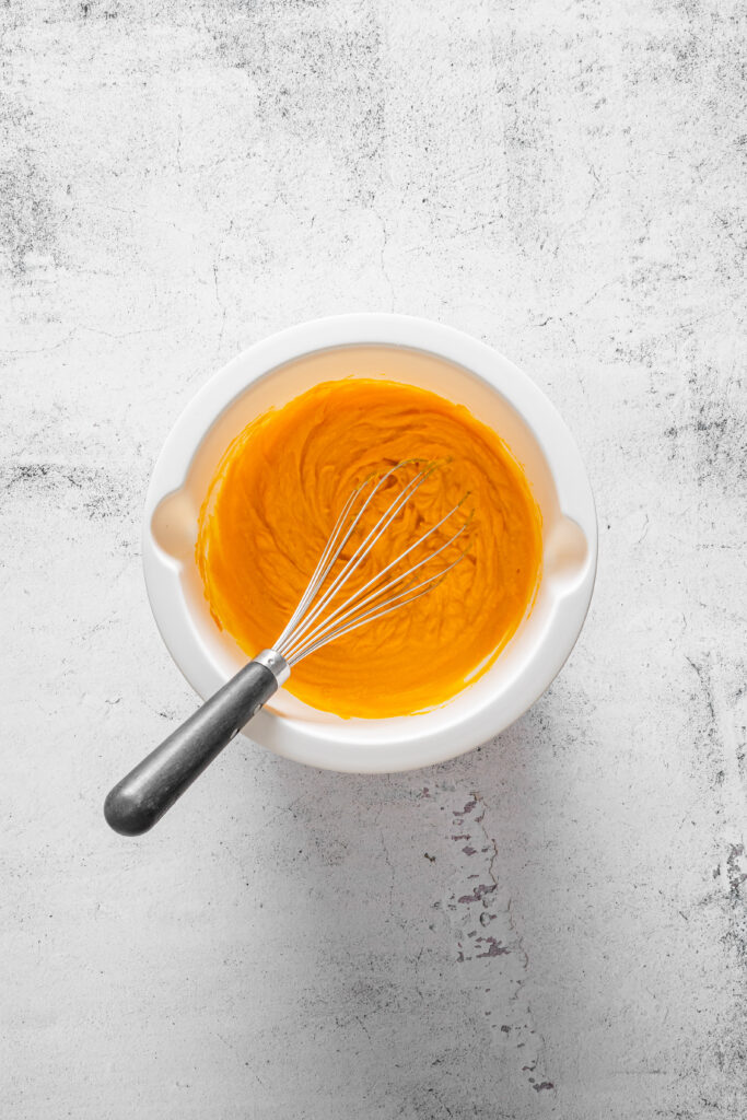 A picture of a pumpkin puree mixture whisked in a bowl.