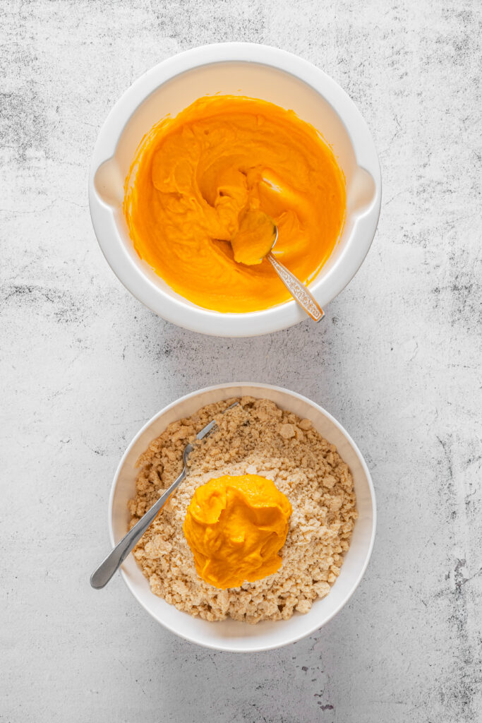 A picture of a pumpkin puree mixture being added to a spiced flour mixture.