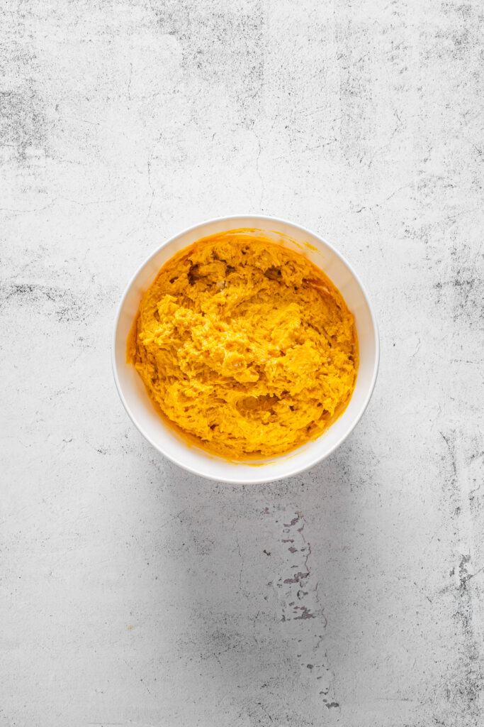 A picture of wet pumpkin spice scone dough in a bowl.