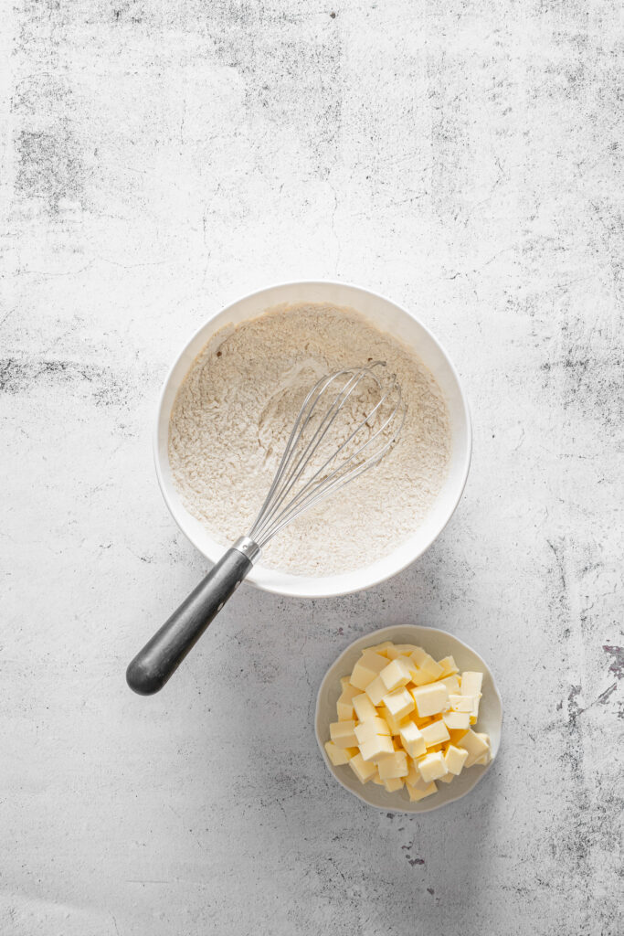 A picture of flour and pumpkin pie spice whisked together in a bowl.