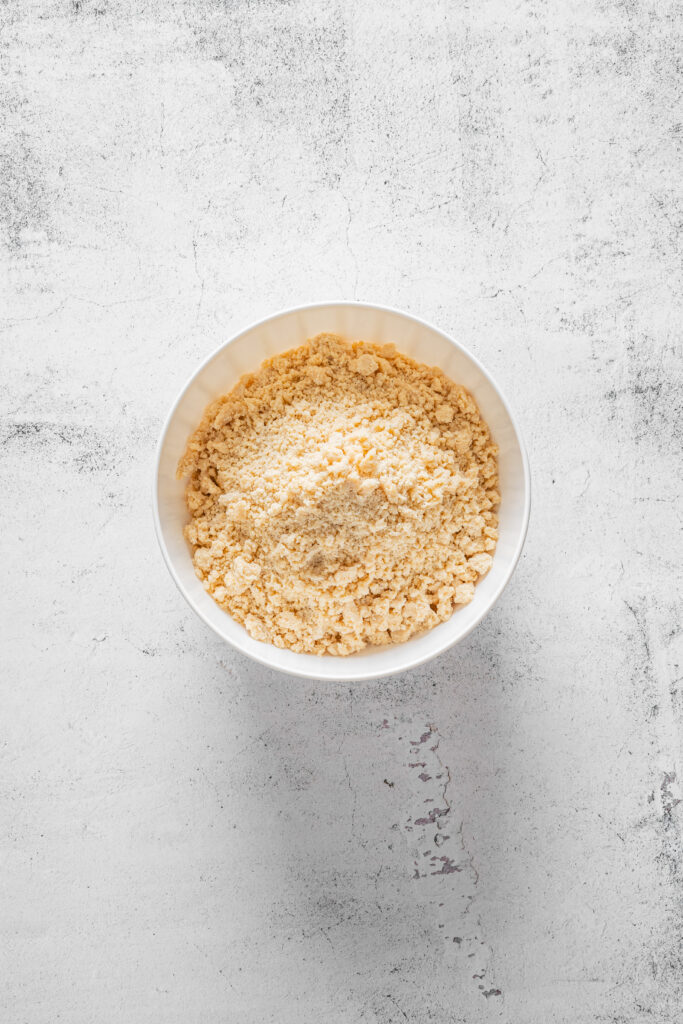 A picture of flour and butter mixed together into a crumb texture.