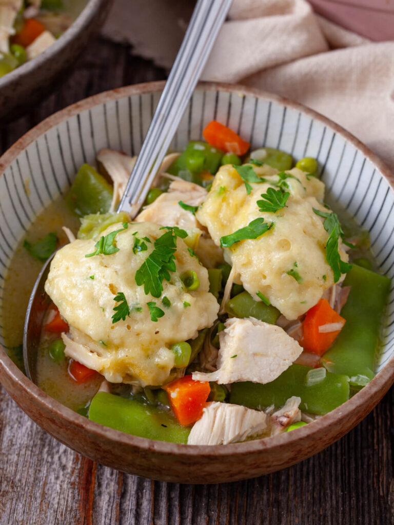 A close up shot of chicken dumplings with soup.