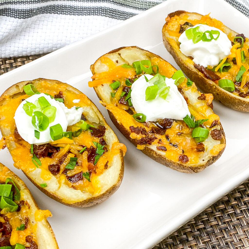 A picture of loaded baked potato skns arranged in a row.