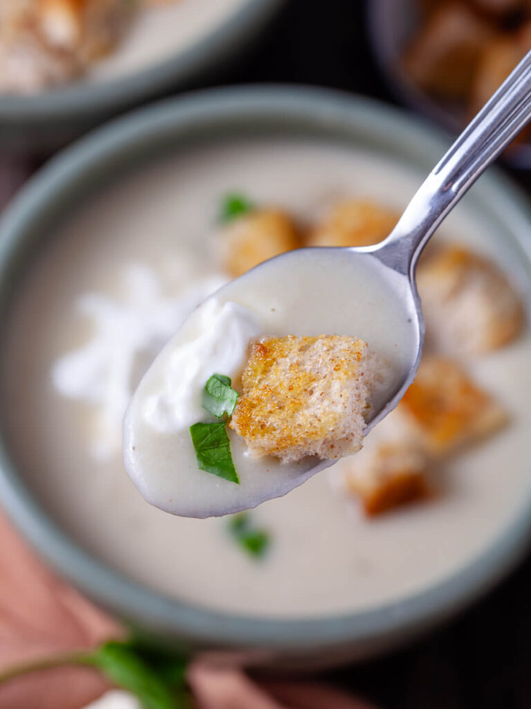 A picture of a spoonful of cauliflower soup.