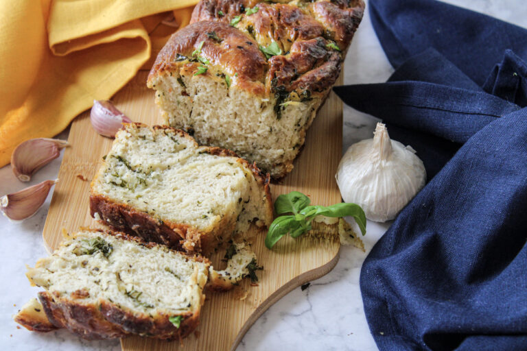 A picture of a loaf and slices of garlic swirl bread.