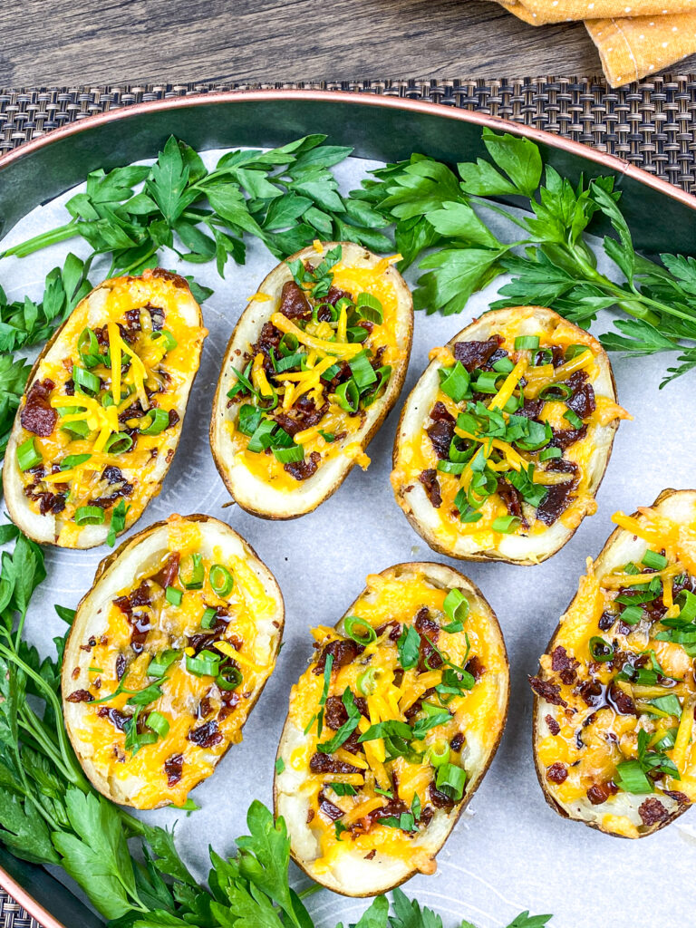 An overhead picture of loaded baked potato skins.