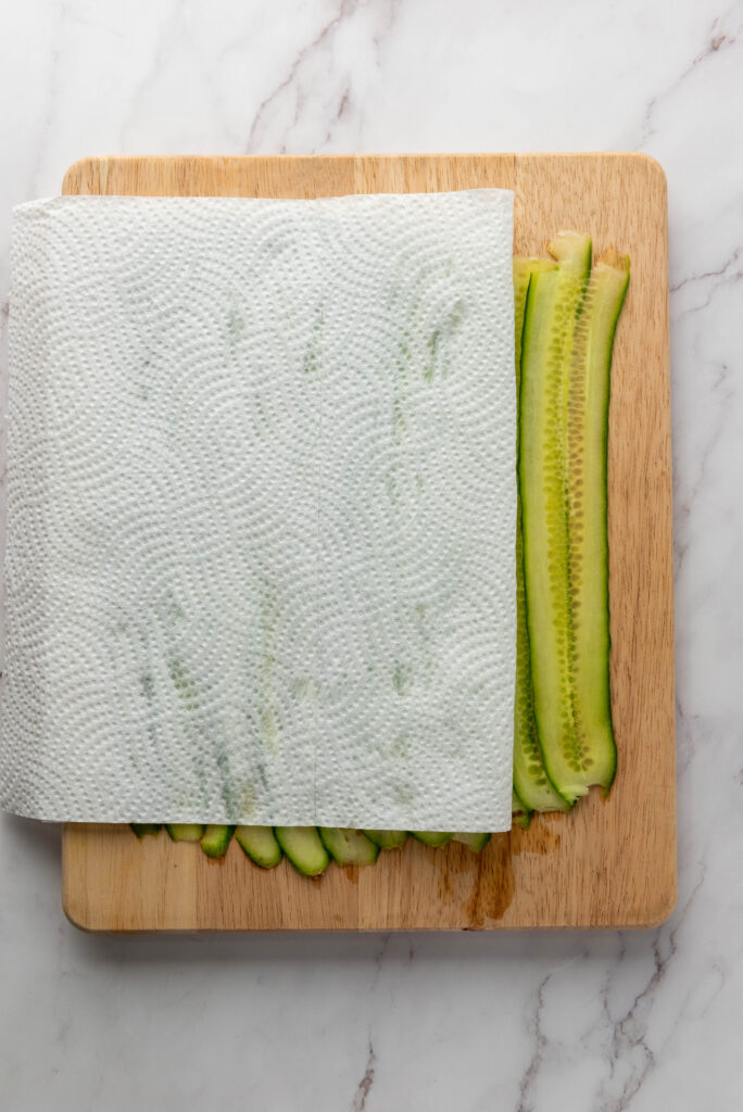 sliced cucumber patted dry with paper towels for cucumber lox rolls