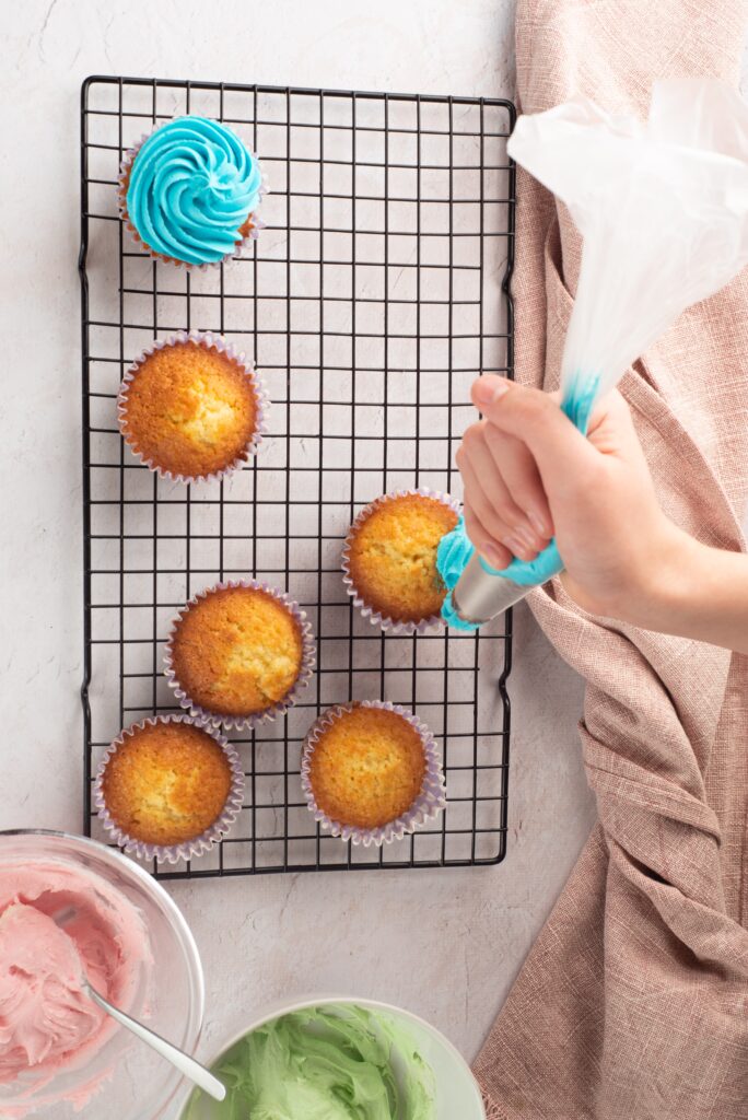 icing placed on cupcakes in a swirl pattern