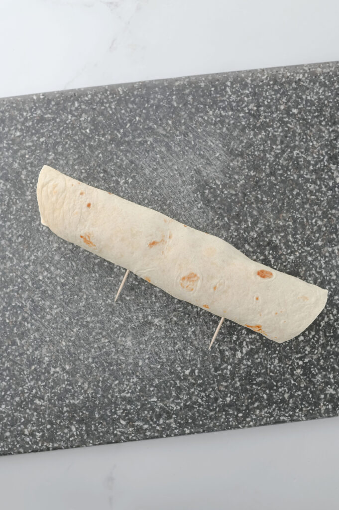 A picture of a tortilla rolled into a log shape.