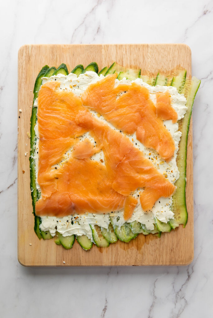 smoked salmon on top of cucumbers and cream cheese